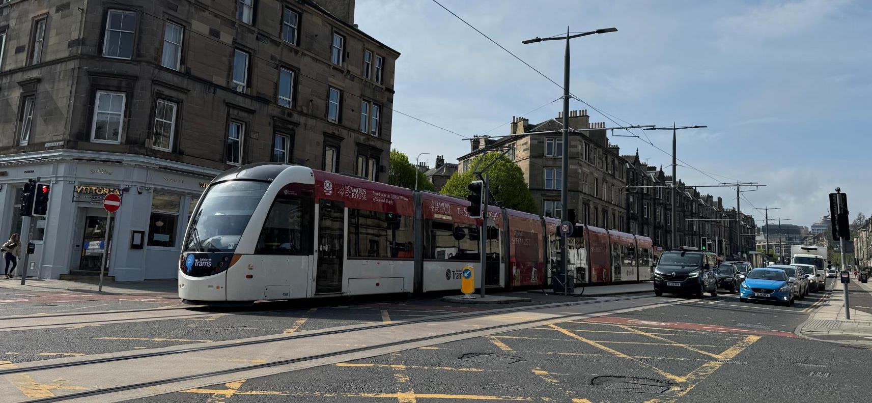 An Edinburgh tram passing Macdonald Road junction as it heads down Leith Walk and toward to the docks