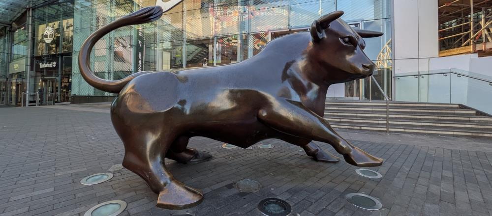 Image of a statue of a bull in front of a building