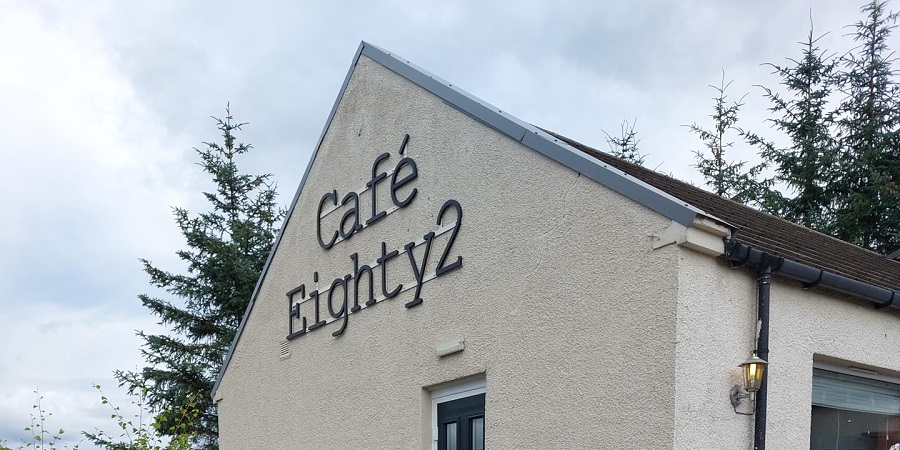 Image of a white building with a name