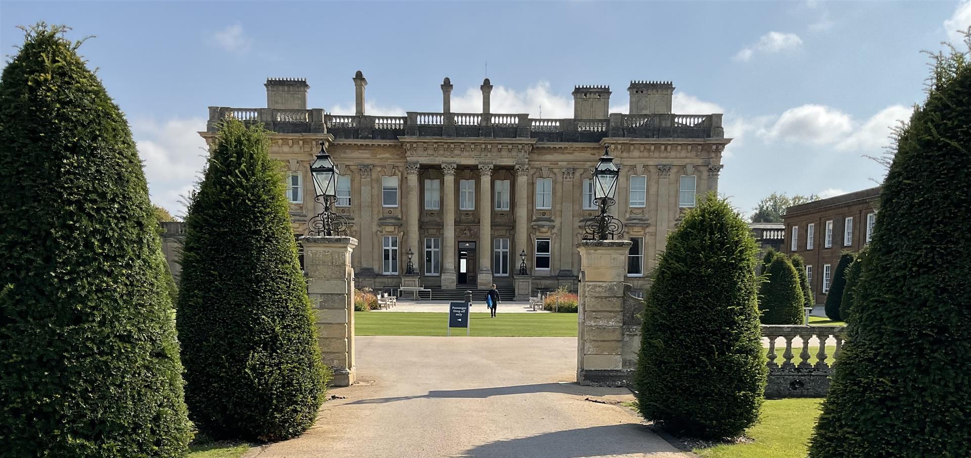 Image of a large building with a lawn and trees