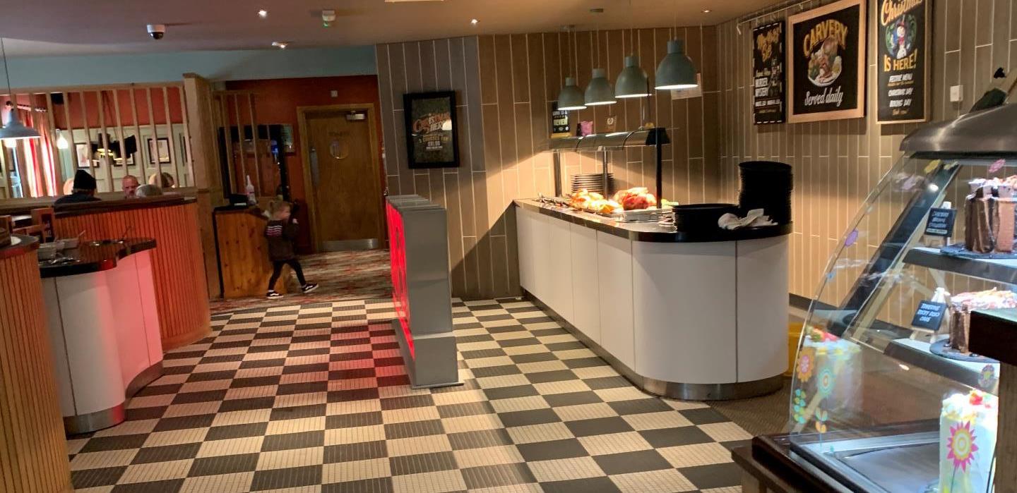 Picture of the pub floor and the toilet sign