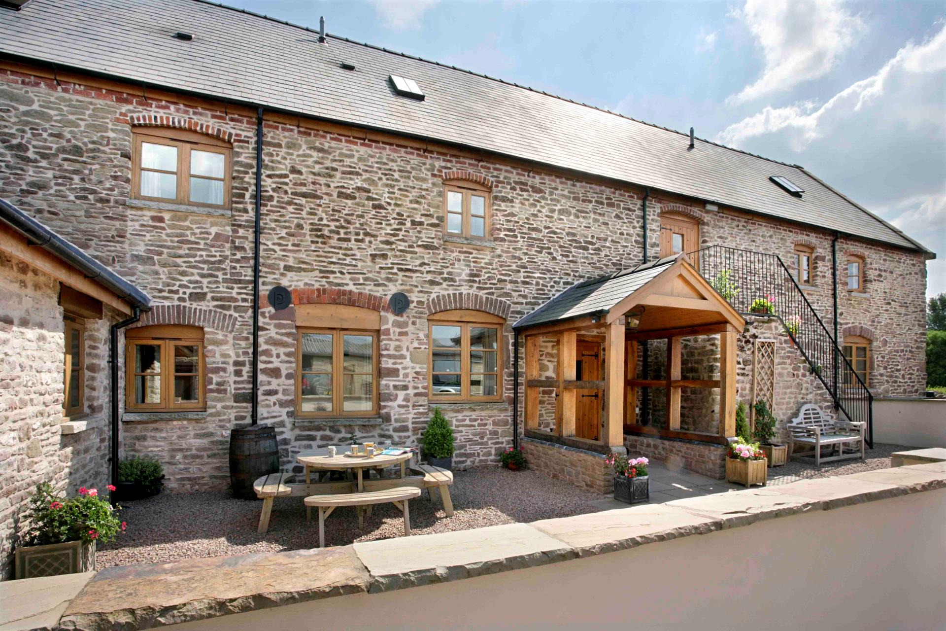 Image of a stone building with a table and chairs