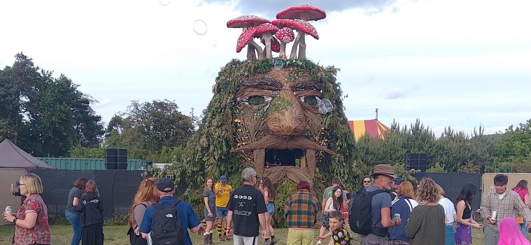 Image of people and a giant sculpted head