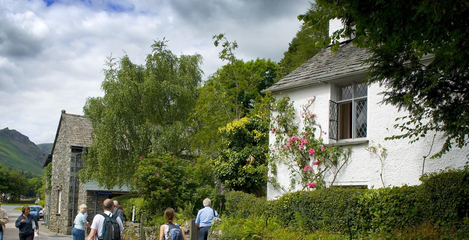 Image of Dove Cottage with people walking past.