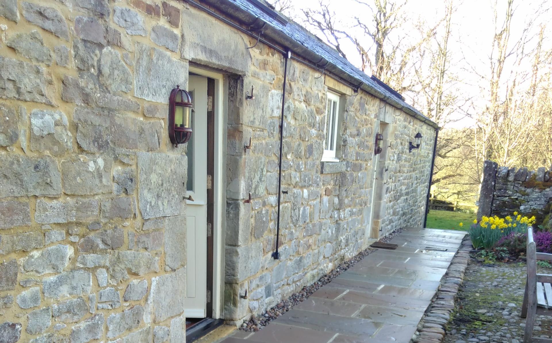 Rear of barn path. First door on left leads to bedroom, second door leads to living area.